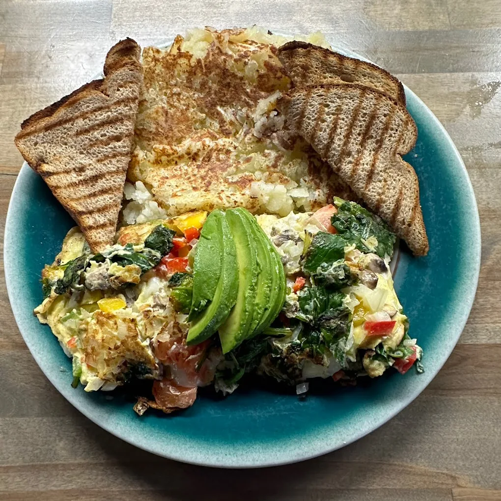 Healthy avocado toast and scrambled eggs breakfast plate served at Peanuts Deluxe Café.