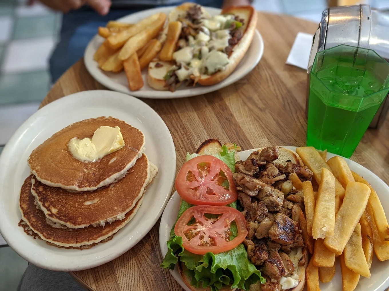 Catering spread featuring Teriyaki Chicken plates, French Fries, and Club Sandwiches for an office lunch